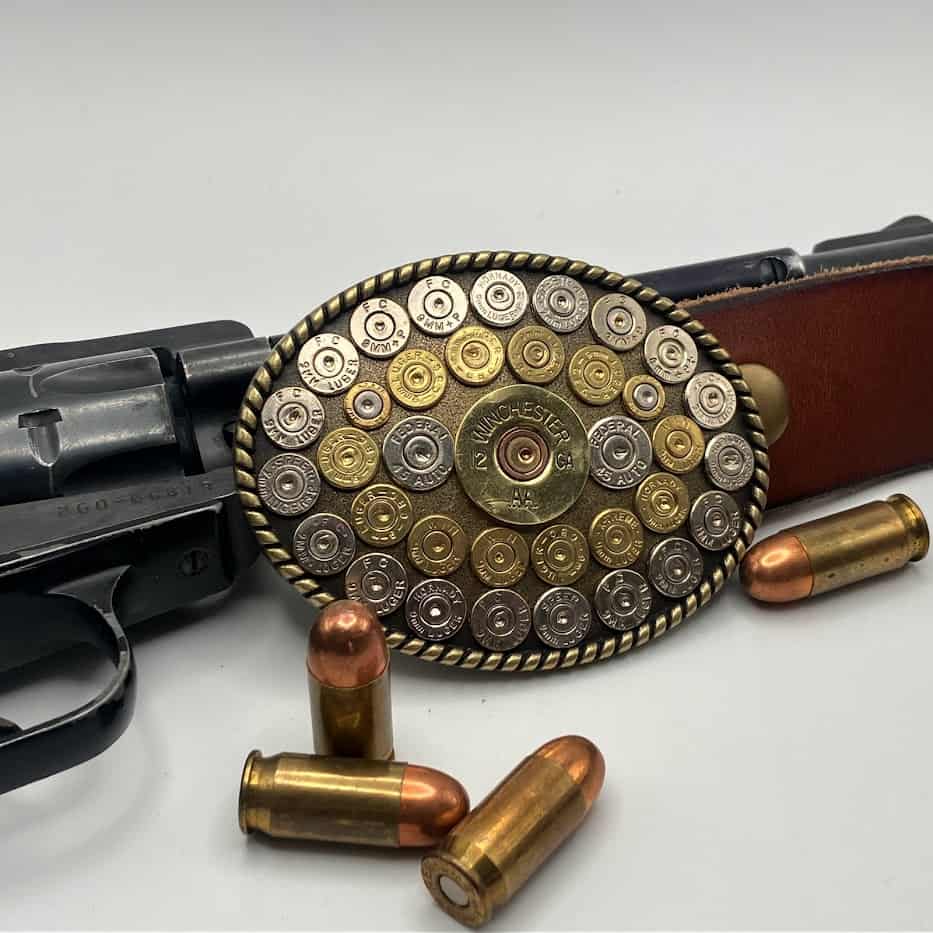 Bullet Casing Belt Buckle with gun and bullets in background